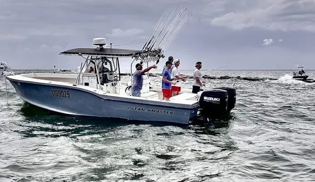 Anglers fishing aboard the Ocean Master, rods bent, nearshore Gulf action